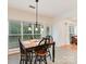 Bright dining area features black chairs, natural light and a modern light fixture over a table at 135 Coronilla Rd, Mooresville, NC 28117