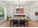Inviting dining area features a large wooden table, seating for six, and patriotic American flag decor at 135 Coronilla Rd, Mooresville, NC 28117