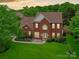 Beautiful two-story brick home featuring a lush lawn and mature landscaping, perfect for families at 135 Coronilla Rd, Mooresville, NC 28117