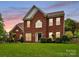 Traditional red brick home with manicured front lawn and mature landscaping at 135 Coronilla Rd, Mooresville, NC 28117