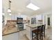 Well-lit kitchen features stainless steel appliances, granite countertops, and a functional island at 135 Coronilla Rd, Mooresville, NC 28117