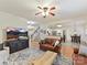 Open-concept living area with stairs, kitchen view, leather sofa, and large television at 135 Coronilla Rd, Mooresville, NC 28117