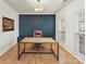Well-lit home office featuring hardwood floors, a modern desk, and a leather chair for a productive workspace at 135 Coronilla Rd, Mooresville, NC 28117