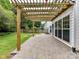 Back patio features a wooden pergola, stone paver floor, and access to the yard at 135 Coronilla Rd, Mooresville, NC 28117