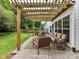 Back patio features a wooden pergola, comfortable outdoor seating, and a stone paver floor at 135 Coronilla Rd, Mooresville, NC 28117