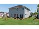 Spacious backyard with lush green grass, a patio area, and manicured landscaping at 138 Shepherds Landing Dr, Mooresville, NC 28115