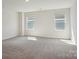 Bright, expansive room with neutral walls, carpet, and two windows at 138 Shepherds Landing Dr, Mooresville, NC 28115