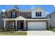 Charming two-story home with brick accents, a two-car garage, and a well-manicured lawn at 138 Shepherds Landing Dr, Mooresville, NC 28115