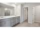 Bathroom featuring double sinks, quartz countertops, and a walk-in shower at 140 Shepherds Landing Dr, Mooresville, NC 28115