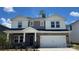 Charming two-story home featuring a stone facade, a two-car garage, and a welcoming front porch at 140 Shepherds Landing Dr, Mooresville, NC 28115