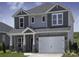 Charming two-story home with stone accents, a two-car garage, and meticulously maintained landscaping at 140 Shepherds Landing Dr, Mooresville, NC 28115