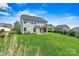 Spacious backyard features lush green lawn, covered patio, and manicured hedges, perfect for outdoor living at 1617 Post Ct, Gastonia, NC 28054