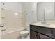 Cozy bathroom with shower-tub, neutral tiles, sleek fixtures, and vanity with storage at 1617 Post Ct, Gastonia, NC 28054