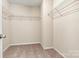 Walk-in closet featuring metal shelving, carpet floor, and neutral colored walls at 1617 Post Ct, Gastonia, NC 28054