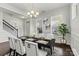 Bright dining room features a decorative chandelier, dark wood table, and stairway access at 1617 Post Ct, Gastonia, NC 28054