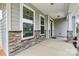 Inviting covered front porch with stone accents, providing a welcoming entry at 1617 Post Ct, Gastonia, NC 28054