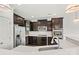 Close up of the kitchen's quartz countertop, stainless steel appliances, and dark wood cabinets at 1617 Post Ct, Gastonia, NC 28054