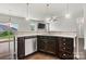 Charming kitchen featuring stainless steel dishwasher, dark wood cabinets, and pendant lighting at 1617 Post Ct, Gastonia, NC 28054