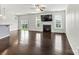 Living room featuring a fireplace, tv, hardwood flooring, and lots of natural light at 1617 Post Ct, Gastonia, NC 28054