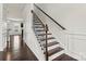 Elegant staircase with dark wood treads and decorative wrought iron railings, flooded with natural light at 1617 Post Ct, Gastonia, NC 28054