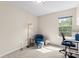 Cozy bedroom featuring neutral walls, a blue chair, and an abundance of natural light at 1620#F Arlyn Cir, Charlotte, NC 28213