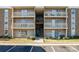 Three-story condo building featuring multiple balconies and updated facade at 1620#F Arlyn Cir, Charlotte, NC 28213
