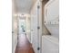 Well-lit hallway featuring wood floors and in-unit laundry machines at 1620#F Arlyn Cir, Charlotte, NC 28213