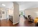 Open-concept living room with hardwood floors, flowing into kitchen at 1620#F Arlyn Cir, Charlotte, NC 28213