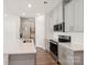 Modern kitchen with stainless steel appliances, gray cabinets, and quartz countertops at 1760 Old Rivers Rd, Concord, NC 28027