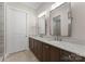 Bathroom boasts a double vanity with granite countertops and modern fixtures at 17728 Jetton Green Loop, Cornelius, NC 28031