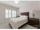 Cozy bedroom with plush carpet, a queen-sized bed, and large windows that offer natural light at 17728 Jetton Green Loop, Cornelius, NC 28031