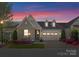 Charming home boasts stone accents, dormer windows, and a well-manicured front yard with colorful flowers at 17728 Jetton Green Loop, Cornelius, NC 28031