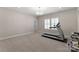 Home gym space features an exercise treadmill, neutral walls, and ample open floor space at 17728 Jetton Green Loop, Cornelius, NC 28031