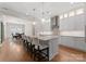 Modern kitchen with stainless steel appliances, granite countertops, and a view of the dining room at 17728 Jetton Green Loop, Cornelius, NC 28031