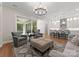 Open-concept living room seamlessly connects to a stylish kitchen with bar seating at 17728 Jetton Green Loop, Cornelius, NC 28031