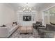Elegant living room featuring custom built-ins, a modern chandelier, and access to the patio at 17728 Jetton Green Loop, Cornelius, NC 28031