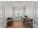 Bright home office features a modern chandelier, plantation shutters, and a functional workspace at 17728 Jetton Green Loop, Cornelius, NC 28031