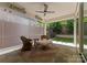 Screened-in patio features comfortable wicker seating, offering a perfect blend of indoor-outdoor living at 17728 Jetton Green Loop, Cornelius, NC 28031