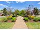 Scenic walkway with trees, plants, and benches lining the path; beautiful landscaping at 17728 Jetton Green Loop, Cornelius, NC 28031