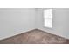 Bedroom featuring carpet flooring, natural lighting, and ample open space at 1834 Teachers House Nw Rd, Concord, NC 28027