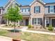 Charming two-story townhome with brick and siding, complimented by a well-manicured lawn at 1834 Teachers House Nw Rd, Concord, NC 28027