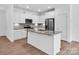 Modern kitchen featuring granite countertops, stainless steel appliances, and a functional island at 1834 Teachers House Nw Rd, Concord, NC 28027