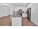 Bright kitchen with granite island, stainless steel appliances, and hardwood floors at 1834 Teachers House Nw Rd, Concord, NC 28027