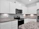 Well-equipped kitchen with stainless steel appliances, granite counters, and ample cabinet space at 1834 Teachers House Nw Rd, Concord, NC 28027