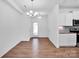 Spacious kitchen with modern lighting and granite countertops, view to eat in area at 1834 Teachers House Nw Rd, Concord, NC 28027