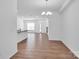 Bright, open-concept living area with wood flooring and modern chandelier at 1834 Teachers House Nw Rd, Concord, NC 28027