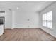 Spacious living room offering hardwood floors and abundant natural light from large windows at 1834 Teachers House Nw Rd, Concord, NC 28027