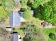 An aerial view showcasing the home's roof, surrounding trees, outbuildings, and yard offering a sense of the property's layout at 2106 4Th Ne St, Hickory, NC 28601