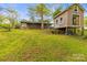 Exterior view of the backyard showcasing a storage shed, treehouse, and inviting open space, perfect for outdoor activities at 2106 4Th Ne St, Hickory, NC 28601