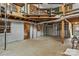 Unfinished basement with exposed ceiling, concrete floors, and access to an upper-level mezzanine with wood and iron accents at 2106 4Th Ne St, Hickory, NC 28601